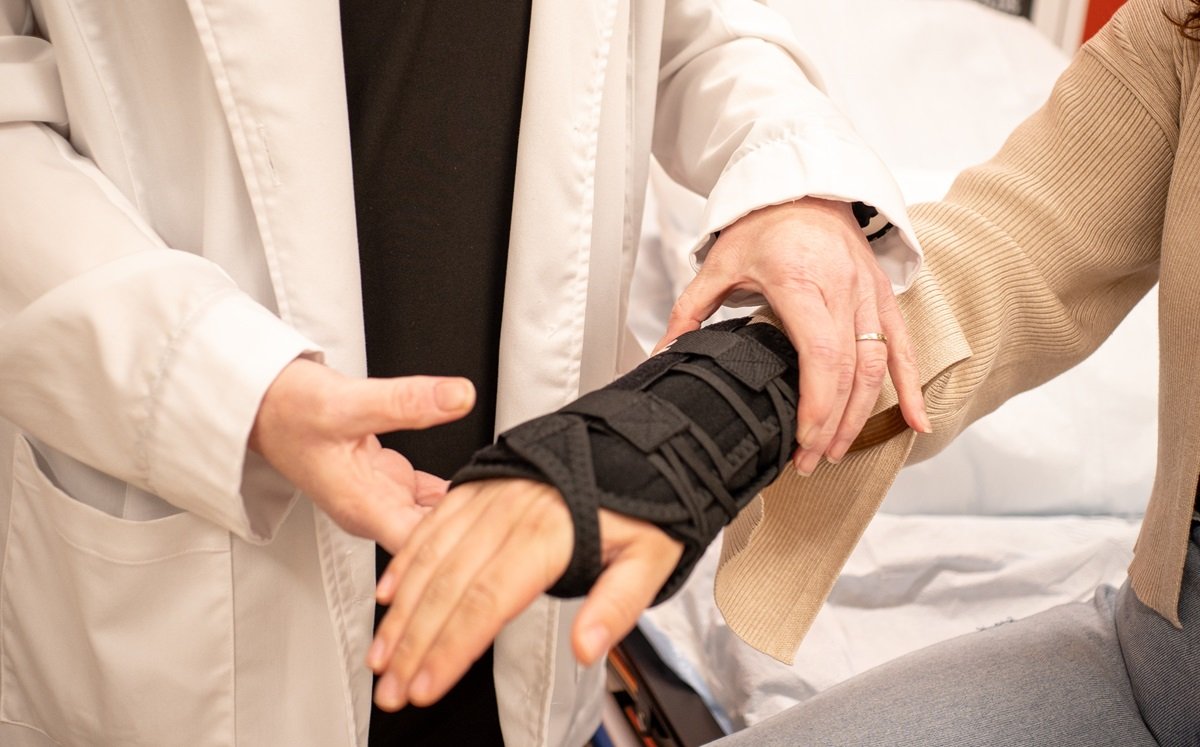Medical provider examining wrist injury Medical provider examining wrist injury