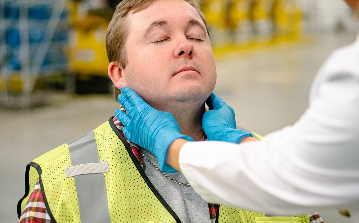 medical provider checking potential employee's glands medical provider checking potential employee's glands during pre-employment services